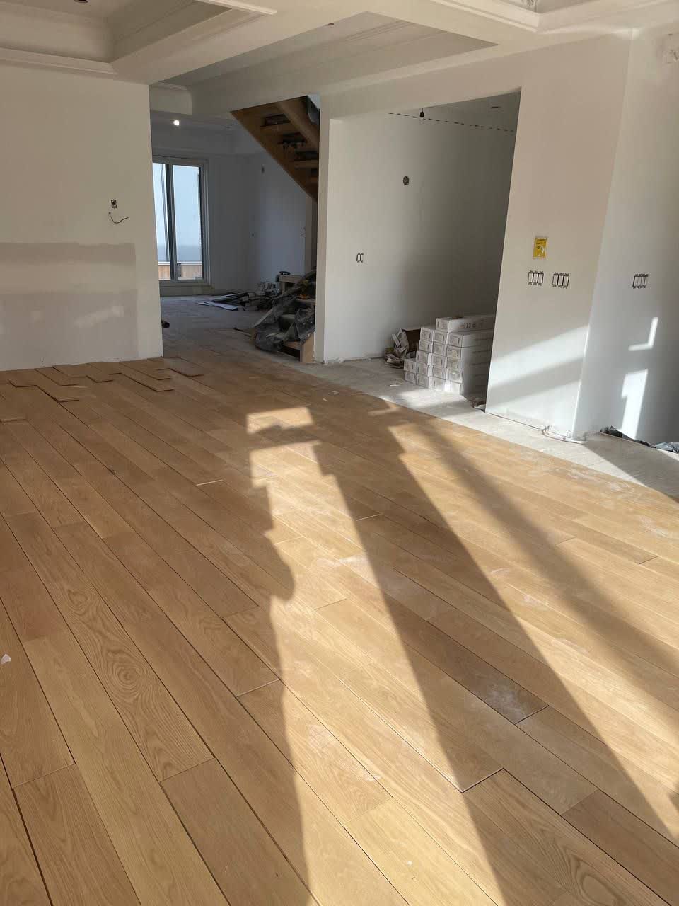 Installation of light colored hardwood flooring