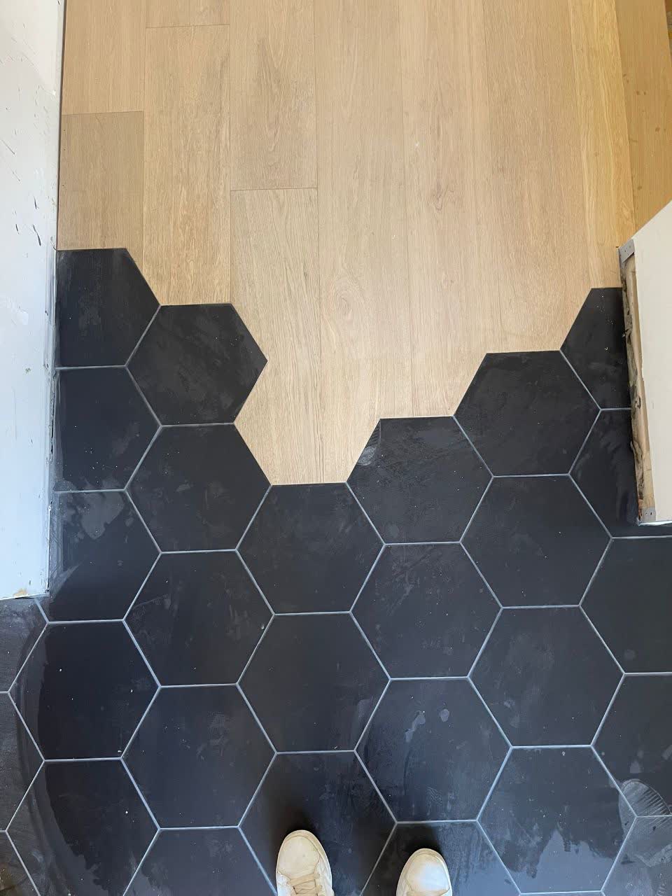 A combination of engineered hardwood and tile flooring